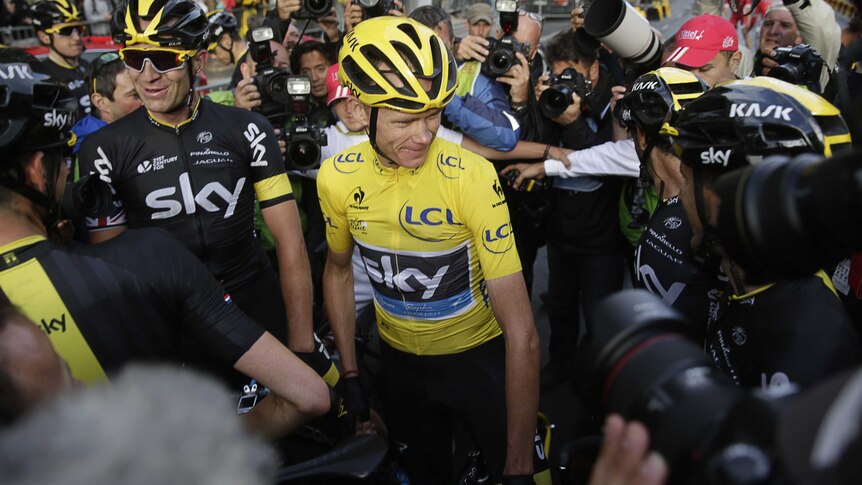 Chris Froome surrounded by photographers after Tour triumph