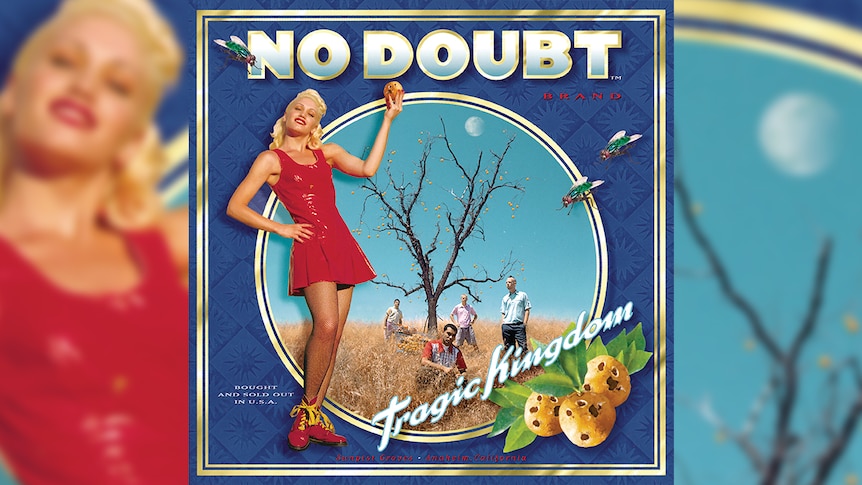 Gwen Stefani wears a red dress and holds up a moldy orange. The rest of her band No Doubt stand around an orange tree.