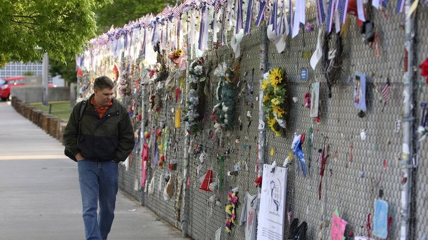 In Oklahoma, a man walks past dedications to the victims of the Murrah Building bombing
