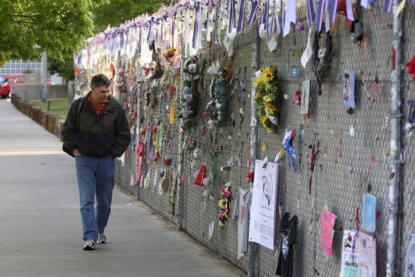 A man walks past dedications to the victims of the Murrah Building bombing