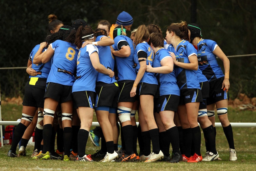 The Western Force women's team huddles together during a training session.