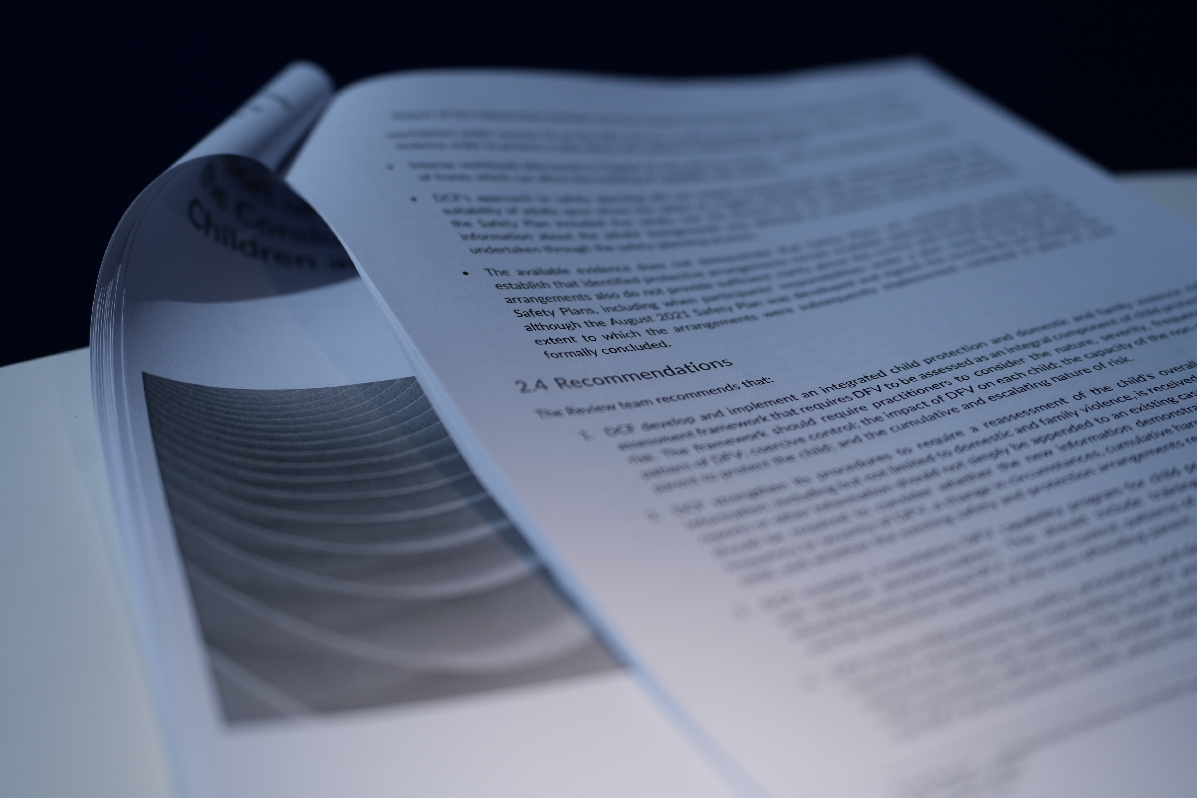 A number of printed pages compiled into a report, the document is open to a page listing a number of recommendations.