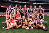 The 18 AFLW captains for 2023 are pictured at Marvel Stadium. Kate Hore is standing in the centre with the Premiership Cup