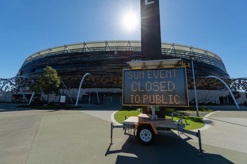 A sign reading "Sun event closed to public" sits outside Optus Stadium before the AFL game between West Coast and Fremantle.