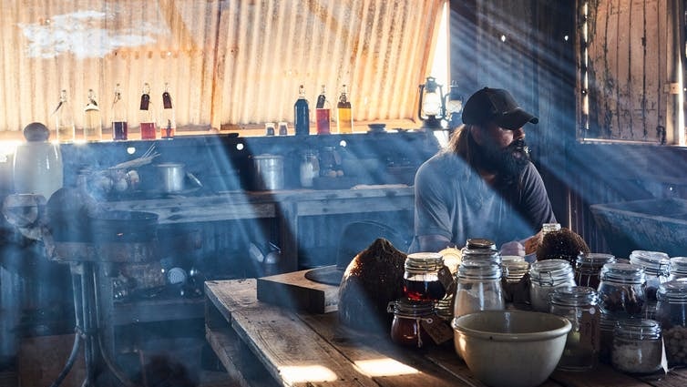 Warwick Thornton at the kitchen table as light filters through the window in The Beach documentary.