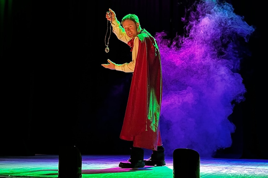 a man pulling a trick with purple smoke