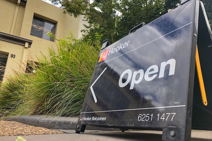 A small black A-frame sign reading "open".
