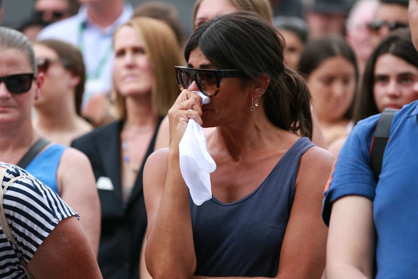 A woman cries at the Bourke Street vigil.