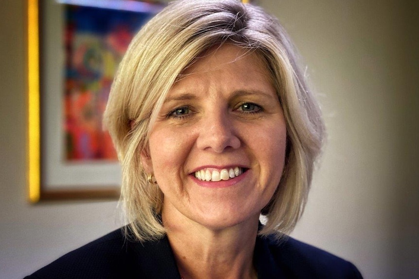 A headshot of Lisa Rodgers in a black jacket in an office.