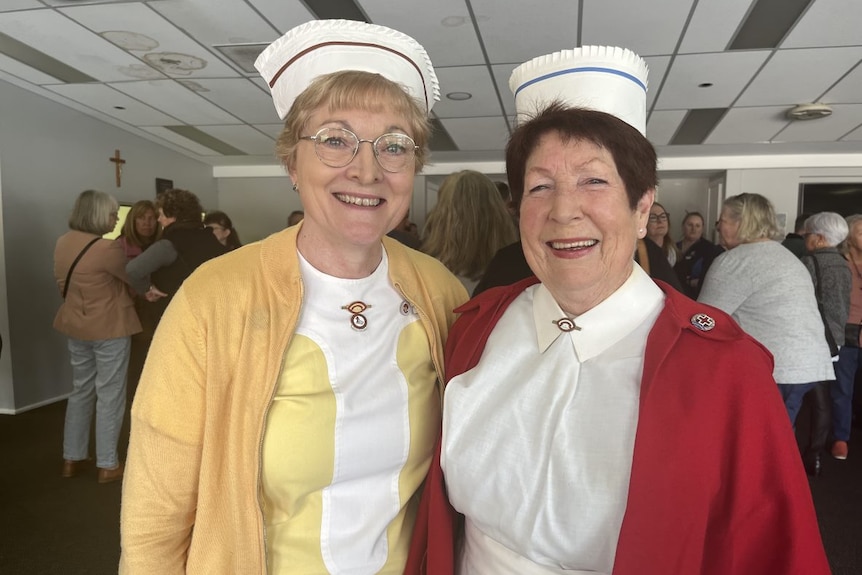 Two women dressed in nurses uniforms 