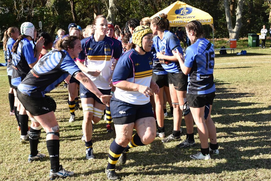 Louise Burrows leads out the ACT women's rugby side