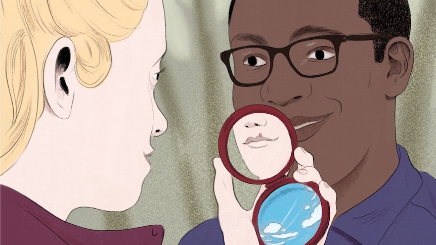 a blonde girl with light skin smiling at a guy with dark skin and hair holding a mirror that shows a blister on her lip