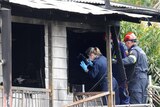 Forensic police take photos at house fire in Wagensveldt St, Slacks Creek