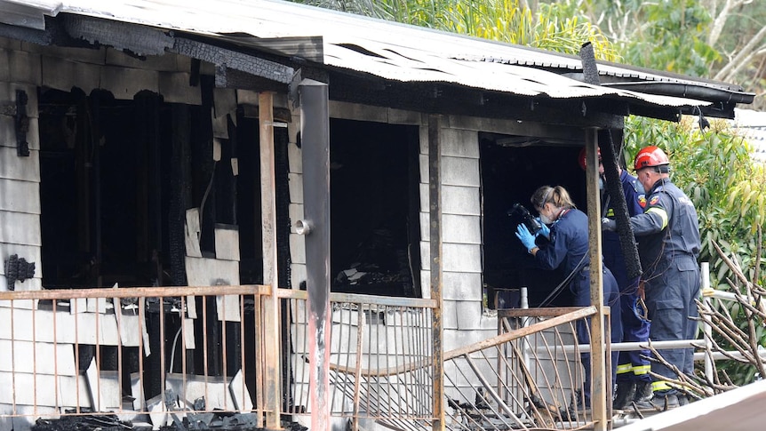 Forensic police take photos at house fire in Wagensveldt St, Slacks Creek