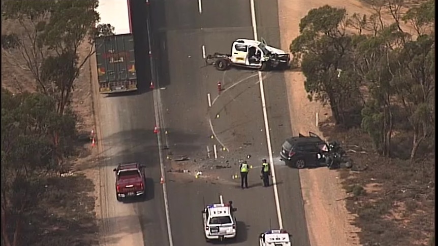 Crashed cars and police cars on a highway from helicopter