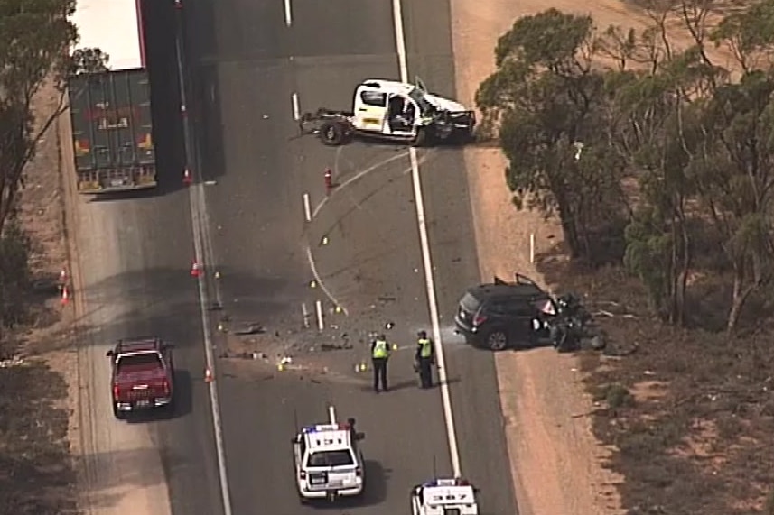 Crashed cars and police cars on a highway from helicopter