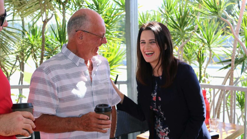 Labor's Dickson candidate Ali France laughs while talking to a man.