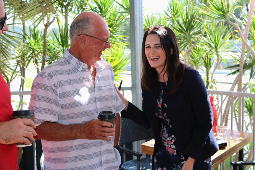 Labor's Dickson candidate Ali France laughs while talking to a man.