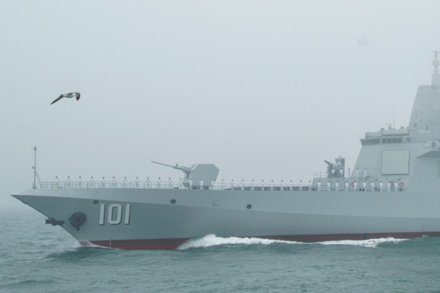 Sailors stand to attention on a Chinese destroyer