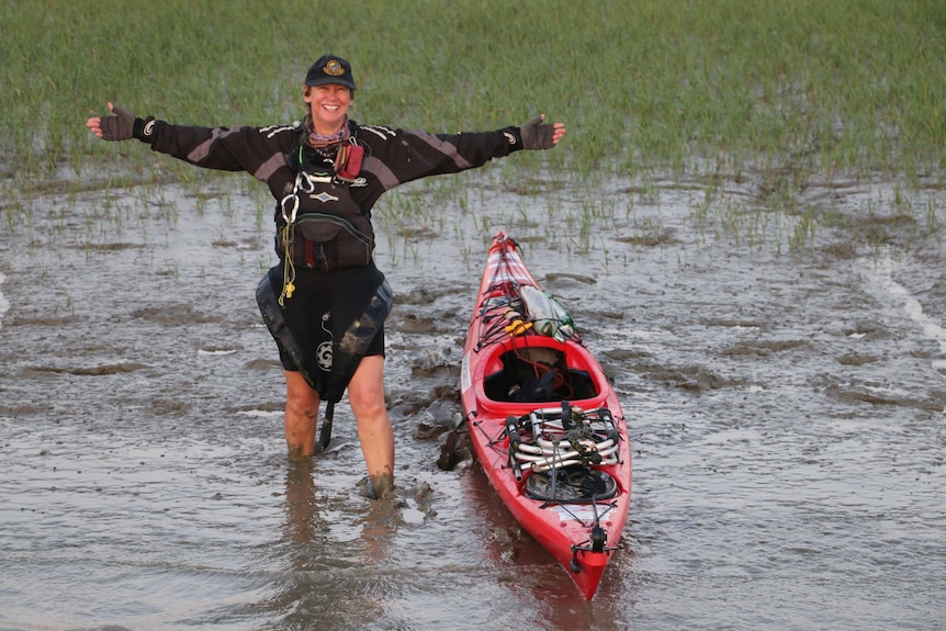 Sandy Robson launches her sea kayak from muddy shores on the Bangladeshi coastline.