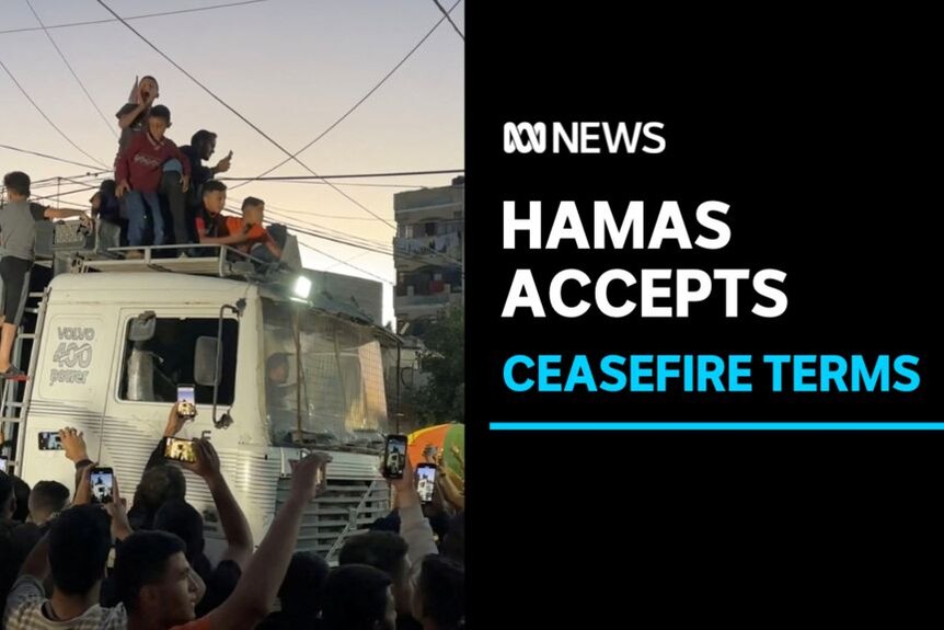 Hamas Accepts, Ceasefire Terms: People hold up phones to film people celebrating on top of a truck's cabin.