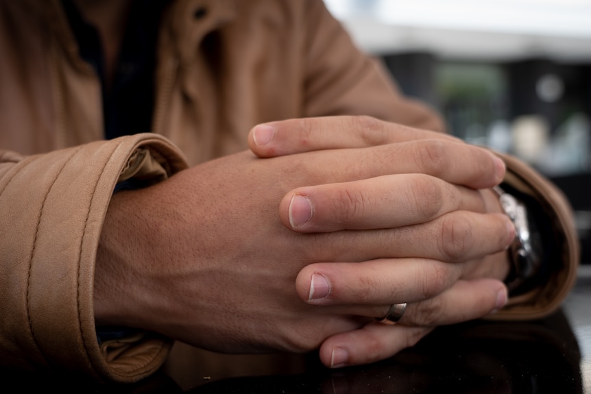 A close up photo of a man's hands.