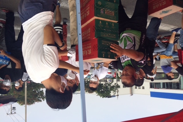 Volunteers hand out food and water at a makeshift shelter at the Taida Second Primary School in Tianjin.