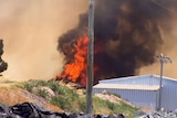 Strong winds and hot conditions fuelled the fast-moving blaze, threatening homes and livestock.