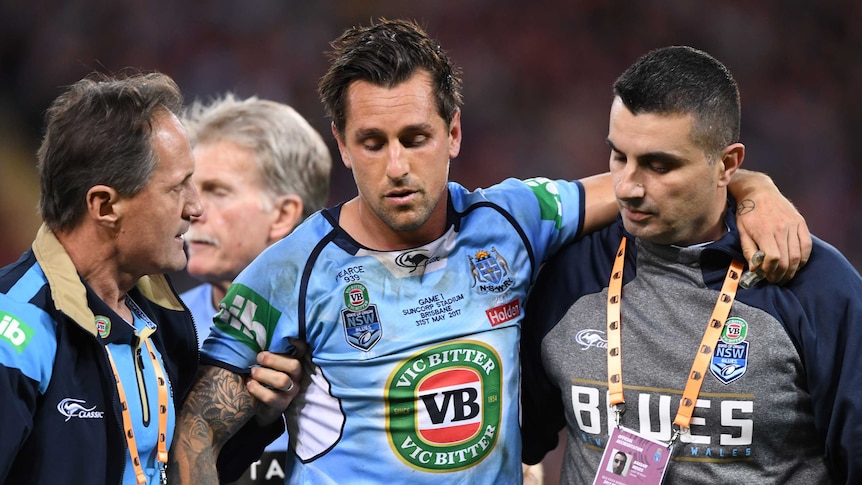 Mitchell Pearce is helped from the field