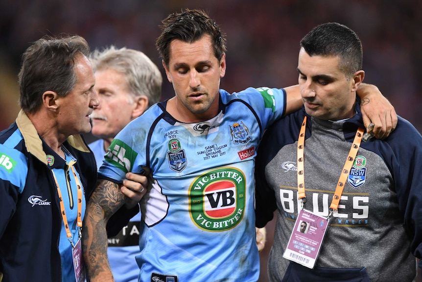 Mitchell Pearce is helped from the field