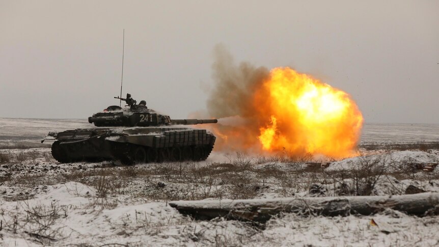 A Russian tank fires as troops take part in drills