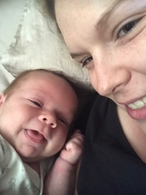 Taryn takes a selfie with her newborn baby.