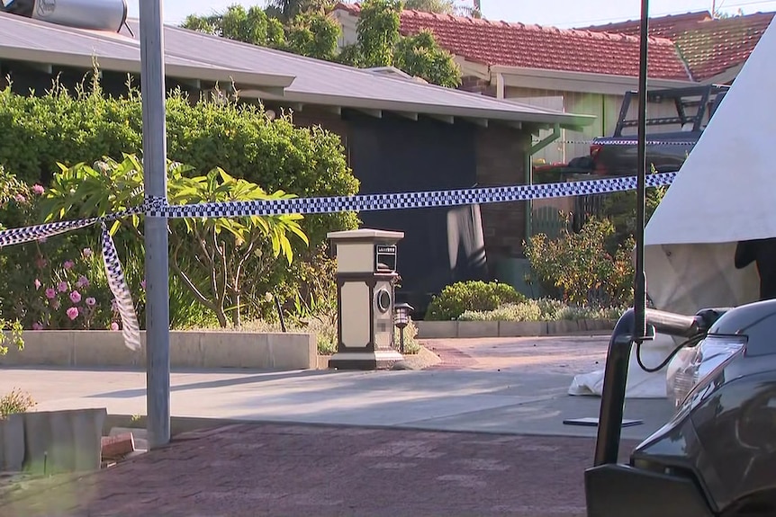 A house on a residential street cordoned off by police tape with a white tent and 4WD partially visible on the right.