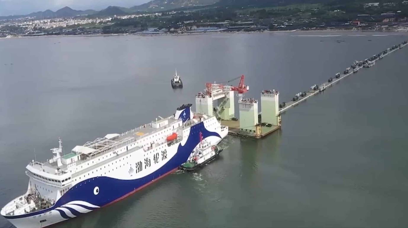 A photo taken from the air of a Chinese ferry docked and unloading armoured vehicles 