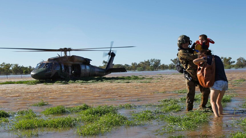 The Army helps a family from a flooded area south of Charleville