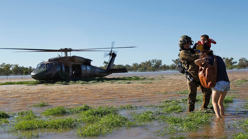 The Army helps a family from a flooded area south of Charleville