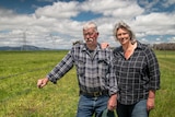 Andrea and Paul Sturgess stand next to a fence.