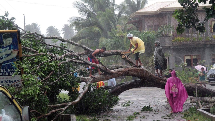 Workers clear a road