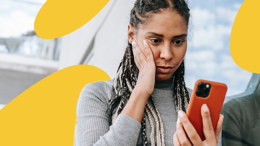 A woman looks confused by what's on her phone.