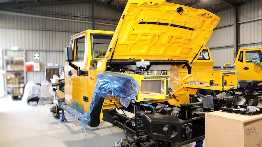 Electric vehicles being assembled on a factory floor