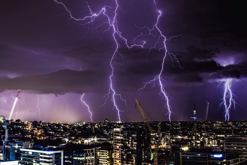 Multiple bolts of lightning light up the sky over Brisbane