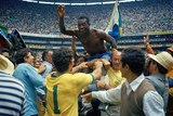 Pele is lifted above the crowd