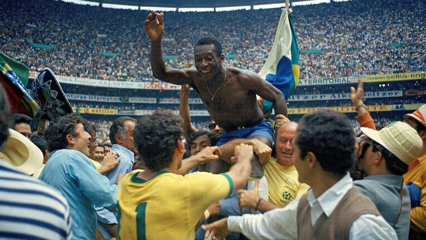 Pele is lifted above the crowd