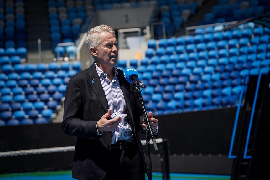 A man in a suit on a tennis court