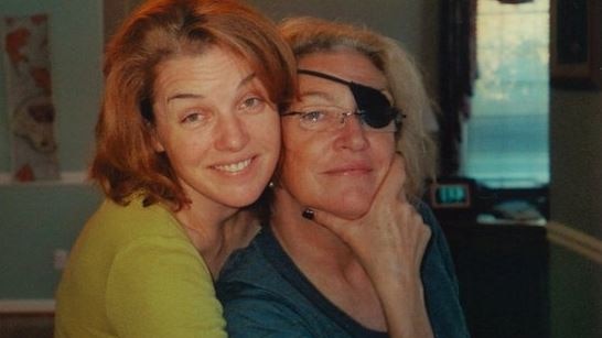Old photo of Cat Colvin with her sister Marie, who has her hand to her chin.