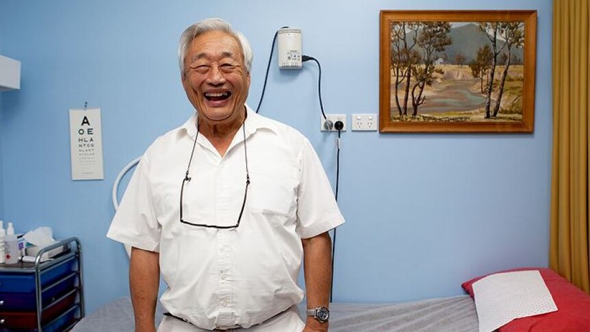 an older man laughing in a doctor's surgery