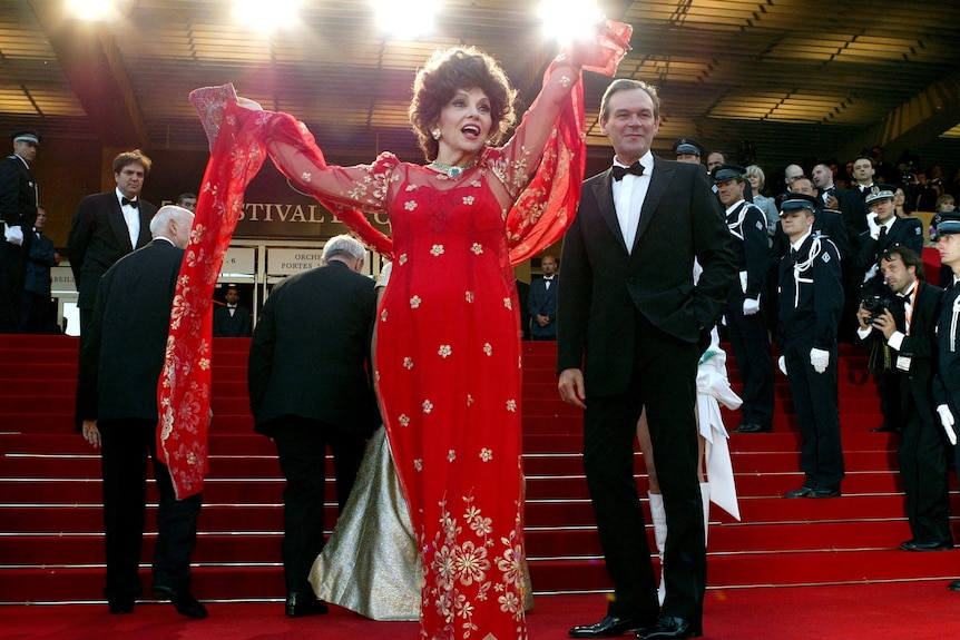 Lollobrigida waves to the crowd during red-carpet arrivals at the 2003 Cannes International Film festival.