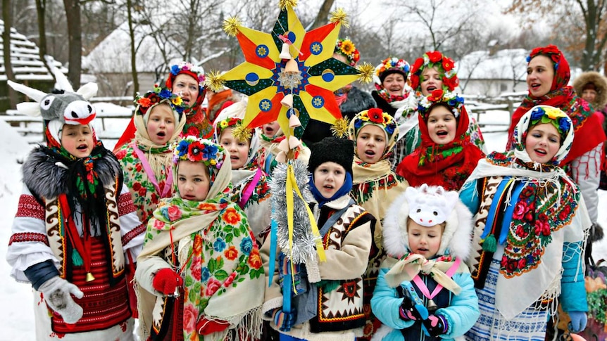 Children dress in traditional costume and sing carols as part of Orthodox Christmas celebrations in the Ukraine.