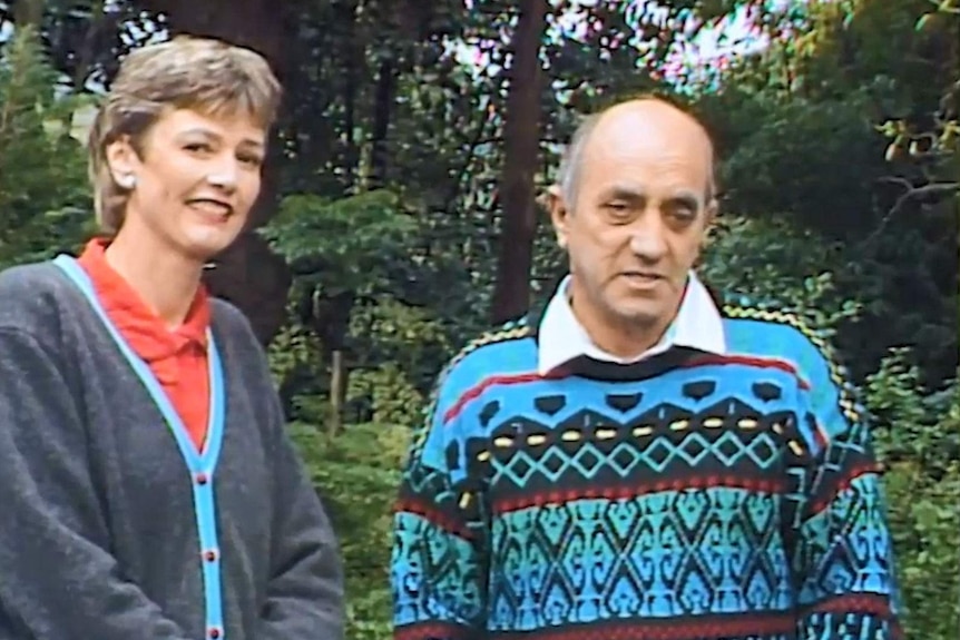 Edmanson and Heinze standing in garden looking to camera.