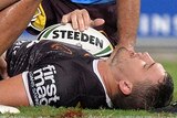 Injury blow ... Corey Oates receives treatment from the Broncos medical staff